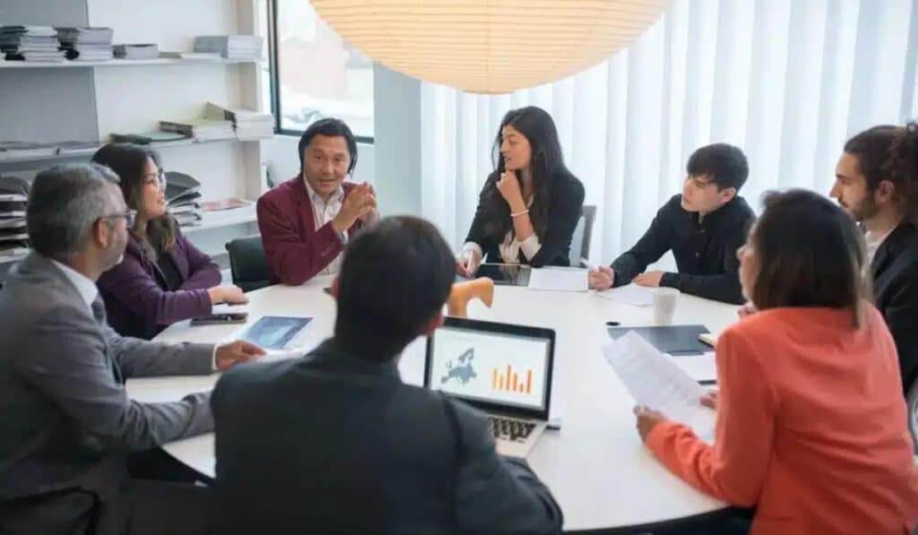 a group of real estate agents having a meeting | Real Estate Management