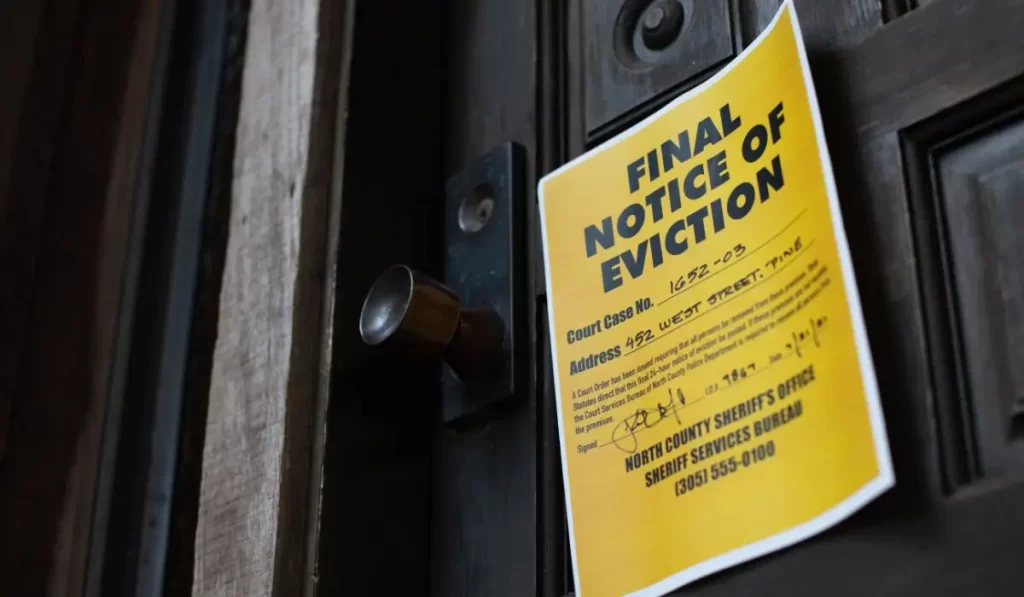 Yellow final eviction notice posted on a tenant’s door during the eviction process in Los Angeles rental.