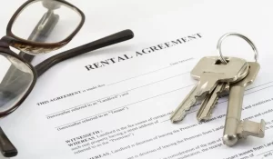 Rental agreement, keys, and glasses used before renting out Huntington Beach property to tenants.